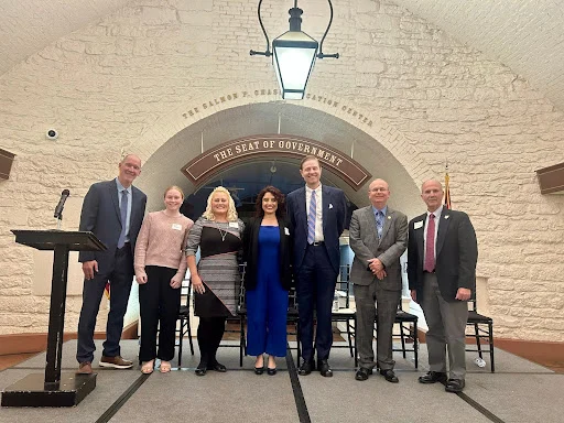 group of people standing in front of stone arch